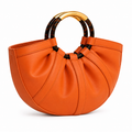 Coccinelle orange half-moon handbag with tortoiseshell handles and gold hardware